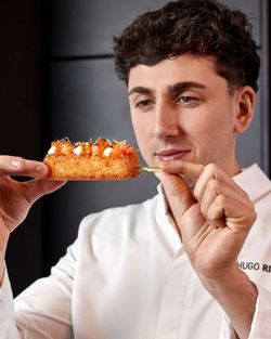 restaurant de sushis : un chef présente une brochette de sushi croustillant avec garnitures variées et œufs de poisson