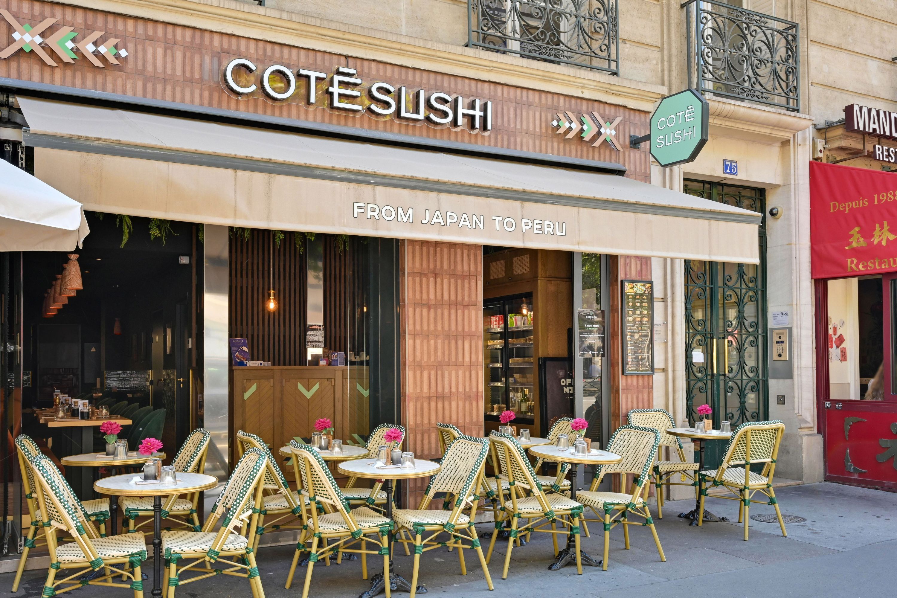 Façade du restaurant japonais Côté Sushi Kléber avec terrasse, tables rondes et chaises en rotin vert et jaune.